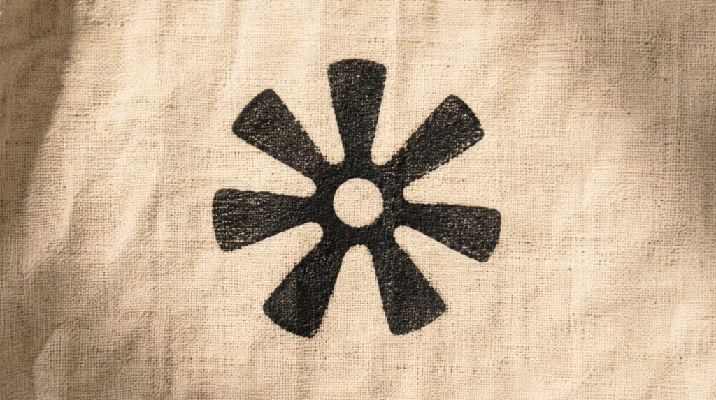 the Ghanaian Adinkra symbol Nsoromma, the star symbol meaning child of the heavens.