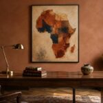 Father's day wall art gift guide image — a single framed abstract Africa map above a walnut desk in a dignified home office