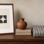 The difference between a symbol and a motif shown side by side — one isolated framed mark beside indigo cloth where the same mark repeats