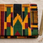 Kente cloth patterns and meanings — folded Asante strip-weave in gold, green, red and black