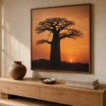 Tree of life symbolism in African art — framed baobab sunset print above oak console with clay vessel and cowrie shells